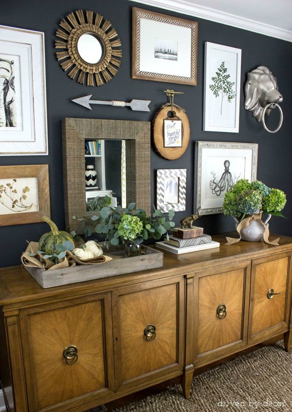 Eclectic-gallery-wall-on-dark-charcoal-walls-console-decorated-will-pumpkins-and-fall-flowers-600