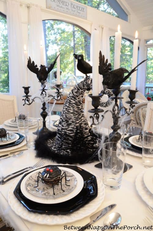 Halloween-Tablescape-with-Spider-Cupcakes-Clock-Plates-a-Witchs-Hat-Centerpiece-crow-naps-porch