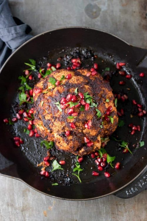 Garlic and Smoked Paprika Whole Roasted Cauliflower in a skillet