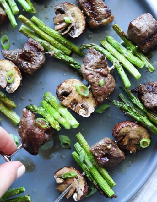 Asian Steak Kebabs with Asparagus and Mushrooms on a baking sheet