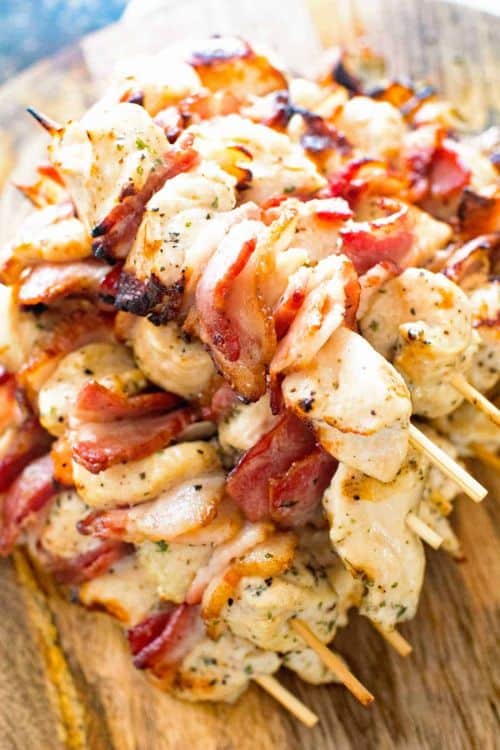 Bacon Ranch Chicken Kabobs with bamboo skewers on a wooden board