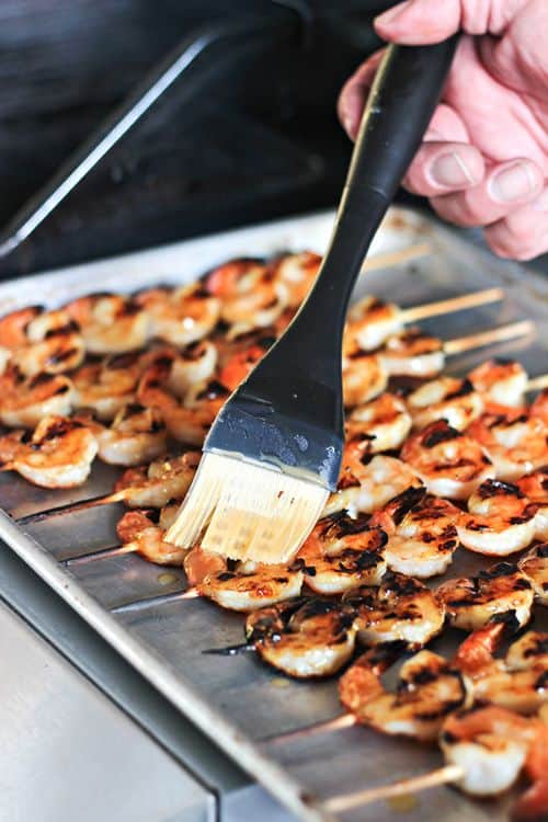 Coconut Rum Grilled Shrimp with bamboo skewers on a baking sheet