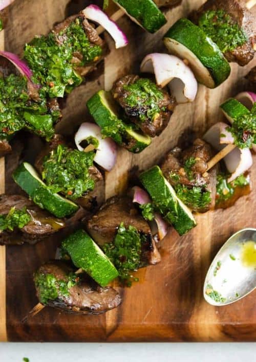 Grilled Steak Kabobs with Cilantro Chimichurri on a wooden board with a spoon