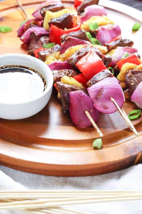  Grilled Steak Kabobs with Homemade Teriyaki Sauce on a wooden plate