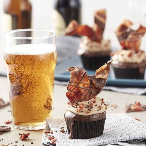maple bacon with chocolate on top of a chocolate cupcake