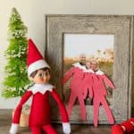 cute elf on the shelf family photo idea