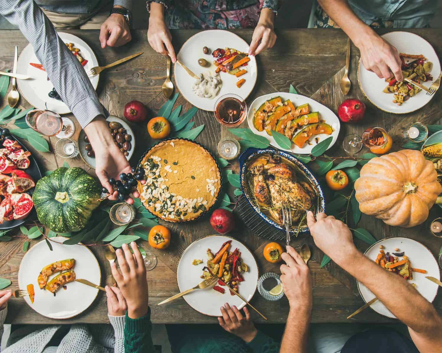 feast table with adults friendsgiving